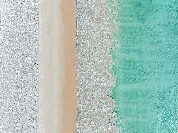 Drone image looking down on Ocean waves rolling onto Cottesloe Beach, Perth, Western Australia, Australia