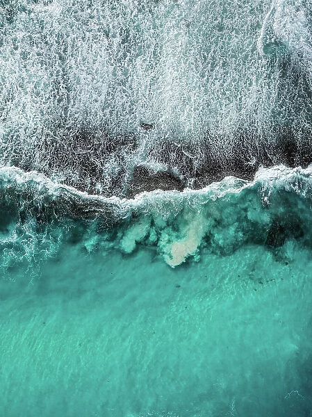 Drone photo showing Ocean waves breaking over an exposed rock formation, Twilight Bay, Esperance, Western Australia, Australia