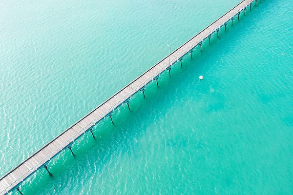 Long jetty out into the clear aqua ocean water