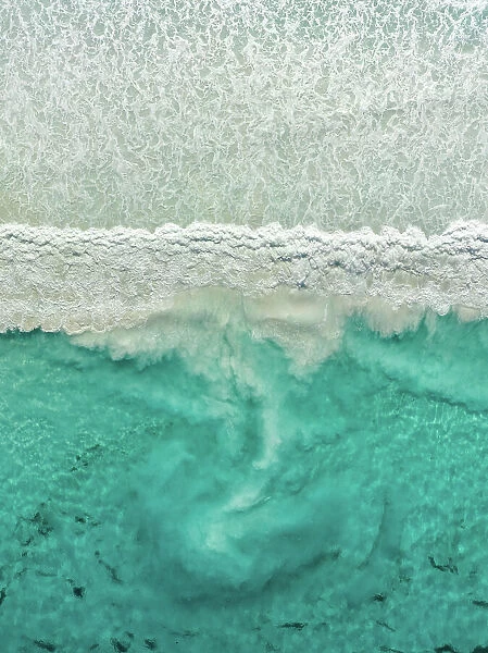 Sediment swirling behind a breaking Ocean wave photographed from directly above, Cape Le Grand National Park, Esperance, Western Australia, Australia