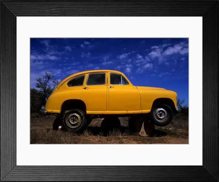 Framed Print : Yellow car on Barrels Framed Print : Yellow car on Barrels