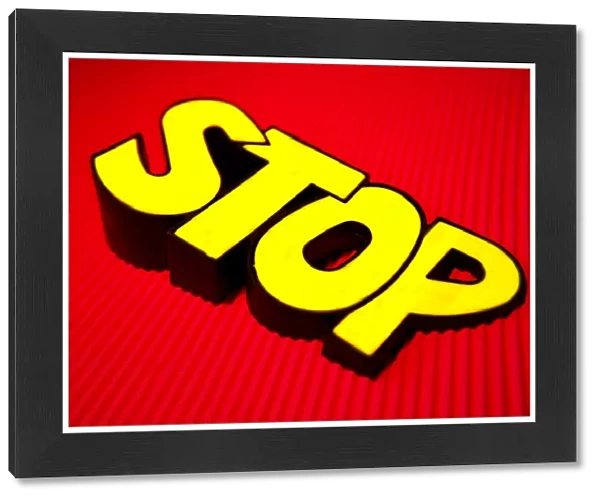 Bright yellow stop sign on red corrugated card