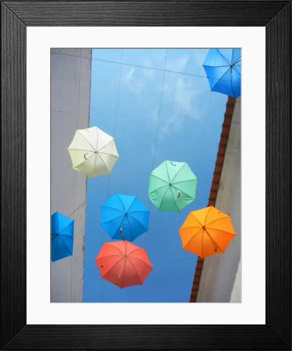 Framed Print : Umbrellas. Artistic installation with umbrellas over street in Evora, Portugal