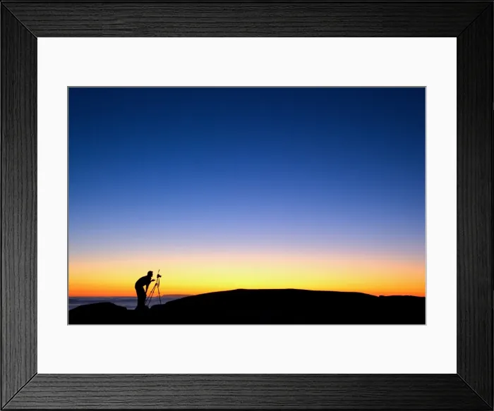 Framed Print : Photographer with camera and tripod