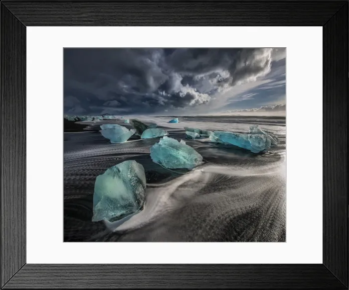 Framed Print : Jokulsarlon Beach in winter, just after a huge storm hit the coastline. Ice bergs from the nearby lagoon have been swept up onto the coastline and surge in and out with the tide Framed Print : Jokulsarlon Beach in winter, just after a huge storm hit the coastline. Ice bergs from the nearby lagoon have been swept up onto the coastline and surge in and out with the tide