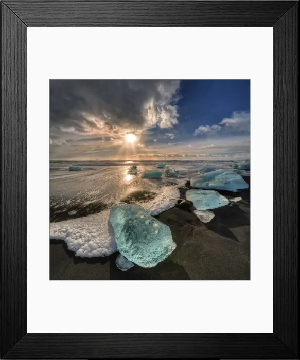 Framed Print : Jokulsarlon Beach in winter, just after a huge storm hit the coastline. Ice bergs from the nearby lagoon have been swept up onto the coastline and surge in and out with the tide