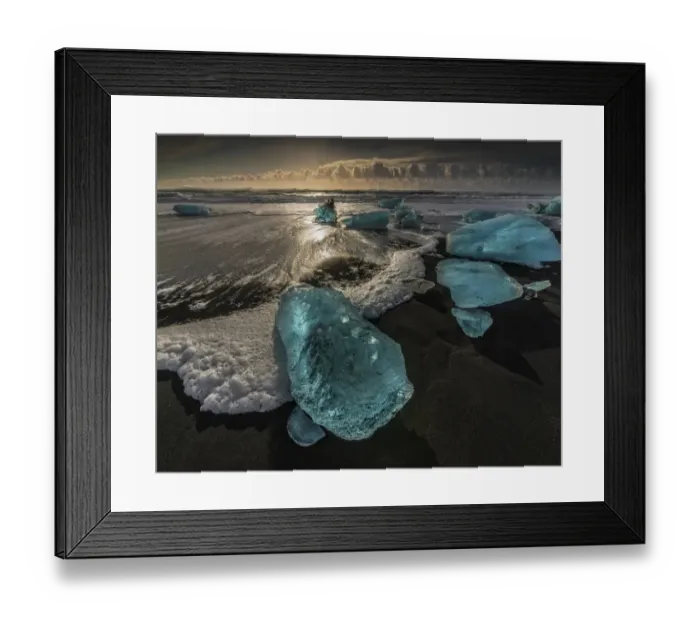 Framed Print : Jokulsarlon Beach in winter, just after a huge storm hit the coastline. Ice bergs from the nearby lagoon have been swept up onto the coastline and surge in and out with the tide Framed Print : Jokulsarlon Beach in winter, just after a huge storm hit the coastline. Ice bergs from the nearby lagoon have been swept up onto the coastline and surge in and out with the tide