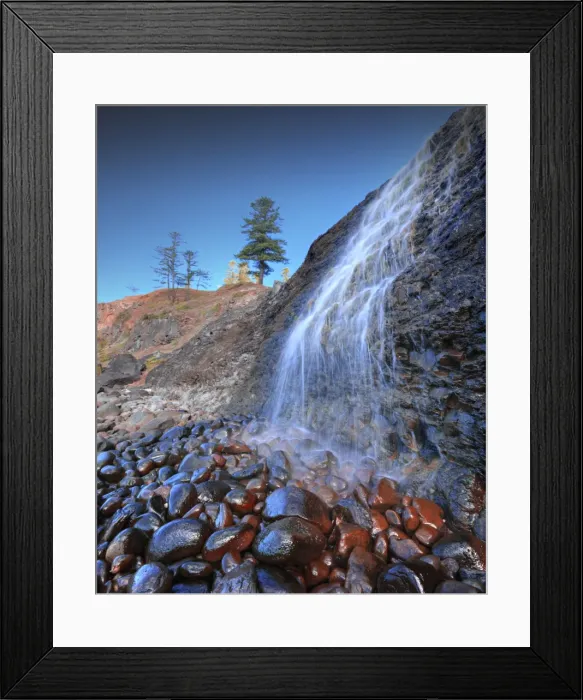 Framed Print : A low angled view of the lower Cockpit falls, which cascade over a steep cliff onto rocks, right on the coastline at Norfolk Island Framed Print : A low angled view of the lower Cockpit falls, which cascade over a steep cliff onto rocks, right on the coastline at Norfolk Island