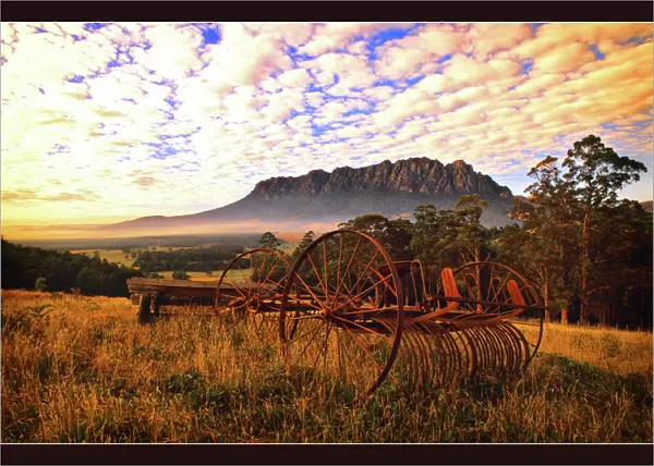 Rusting old agricultural machinery sitting in a filed near Mount Roland, Central Tasmania