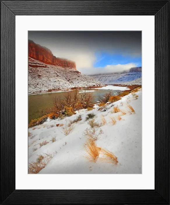 Framed Print : A winter mantle of snow lies along the banks of the Colorado river near Moab in Utah