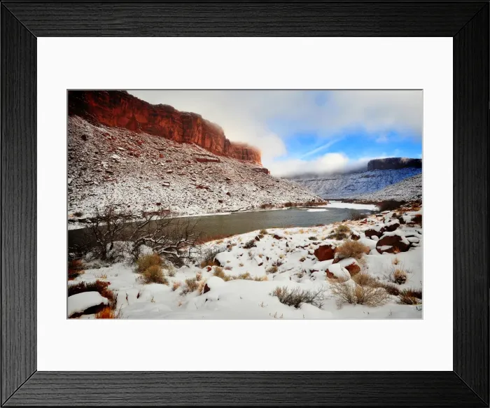 Framed Print : A winter mantle of snow lies along the banks of the Colorado river near Moab in Utah