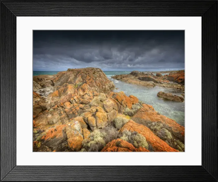 Framed Print : Half moon bay on the West coastline of King Island, has large rock-pools and magnificent red coloured lichen boulders of pink granite. Bass Strait, Tasmania