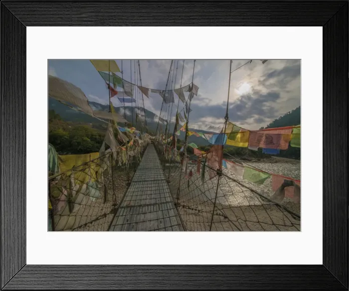Framed Print : Prayer flags flutter in the breeze on a suspended footbridge over the Punakha river, Bhutan Framed Print : Prayer flags flutter in the breeze on a suspended footbridge over the Punakha river, Bhutan