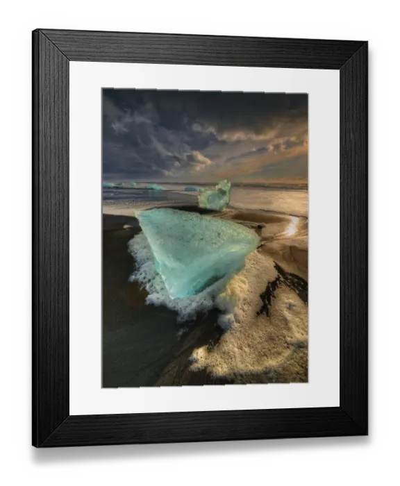 Framed Print : Jokulsarlon Beach in winter, just after a huge storm hit the coastline. Ice bergs from the nearby lagoon have been swept up onto the coastline and surge in and out with the tide Framed Print : Jokulsarlon Beach in winter, just after a huge storm hit the coastline. Ice bergs from the nearby lagoon have been swept up onto the coastline and surge in and out with the tide