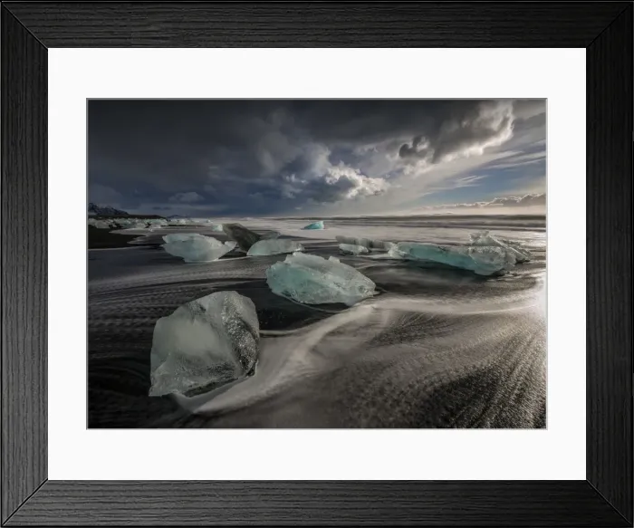 Framed Print : Jokulsarlon Beach in winter, just after a huge storm hit the coastline. Ice bergs from the nearby lagoon have been swept up onto the coastline and surge in and out with the tide Framed Print : Jokulsarlon Beach in winter, just after a huge storm hit the coastline. Ice bergs from the nearby lagoon have been swept up onto the coastline and surge in and out with the tide