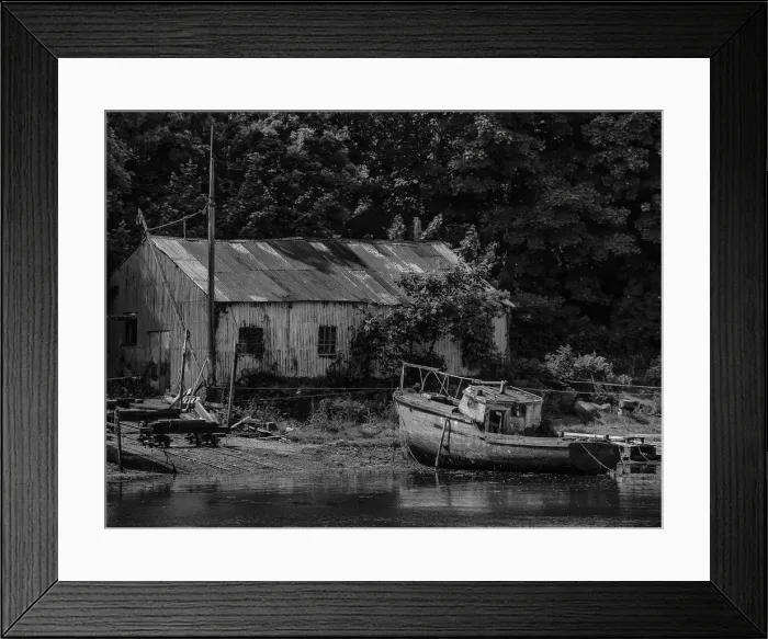 Framed Print : Old boatshed and derelict fishing boat moored on the river at Caernarfon, Northern Wales, United kingdom