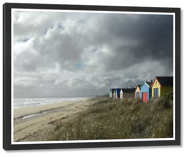 Clouds over beach with huts