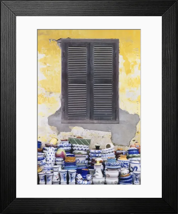 Framed Print : Stacks of Pottery by Window