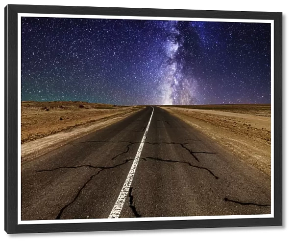 Road in the desert at night with the Milky Way