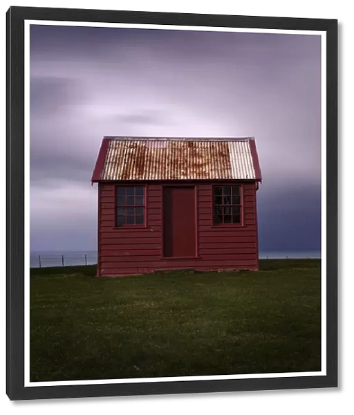 Red shed with stormy clouds