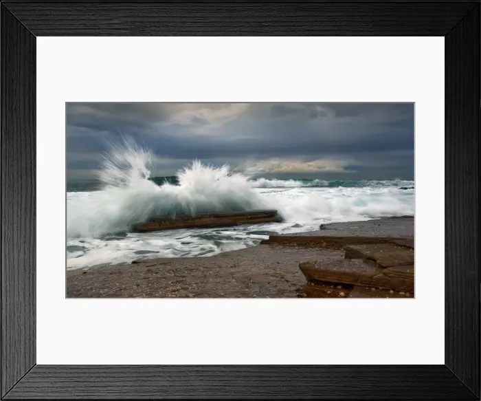 Framed Print : Waves splashing over rock