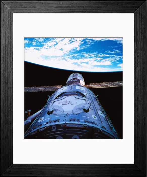 Framed Print : A satellite orbiting above earth