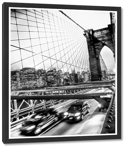 Two SUVs speed along the Brooklyn Bridge