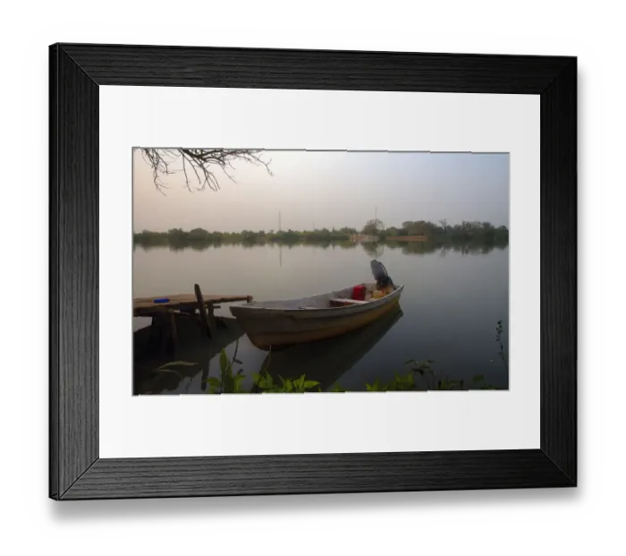 Framed Print : Small Fishing boat on banks of river Gambia in early morning before sunrise Framed Print : Small Fishing boat on banks of river Gambia in early morning before sunrise