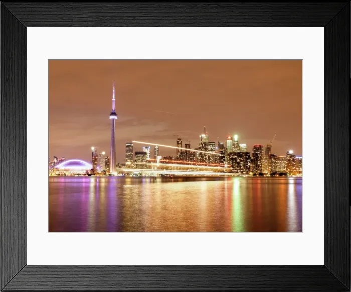 Framed Print : Canada, Ontario, Toronto, Illuminated waterfront skyline and CN Tower reflecting in Lake Ontario with passing ferry light trails Framed Print : Canada, Ontario, Toronto, Illuminated waterfront skyline and CN Tower reflecting in Lake Ontario with passing ferry light trails
