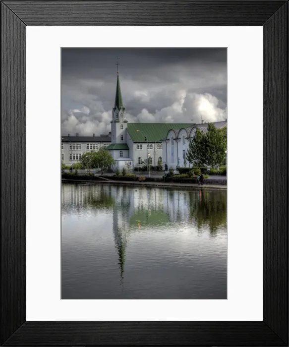Framed Print : Frikirkjan church Tjornin lake cloudy reflections