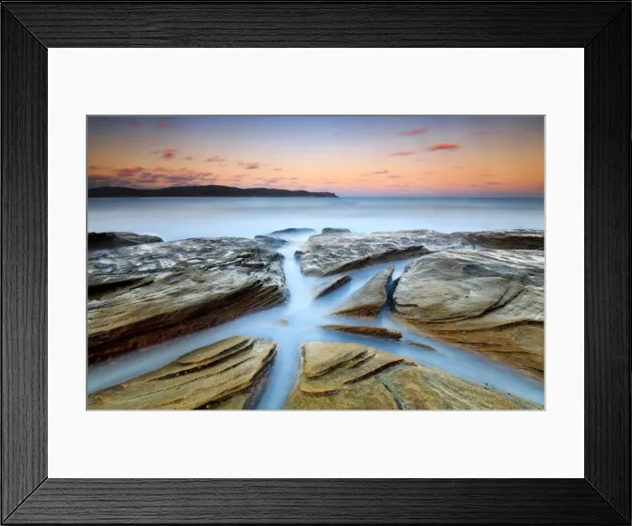 Framed Print : Pastel sunset over rock platform