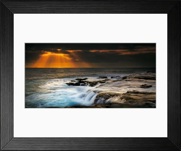 Framed Print : Sunbeams over stormy sea
