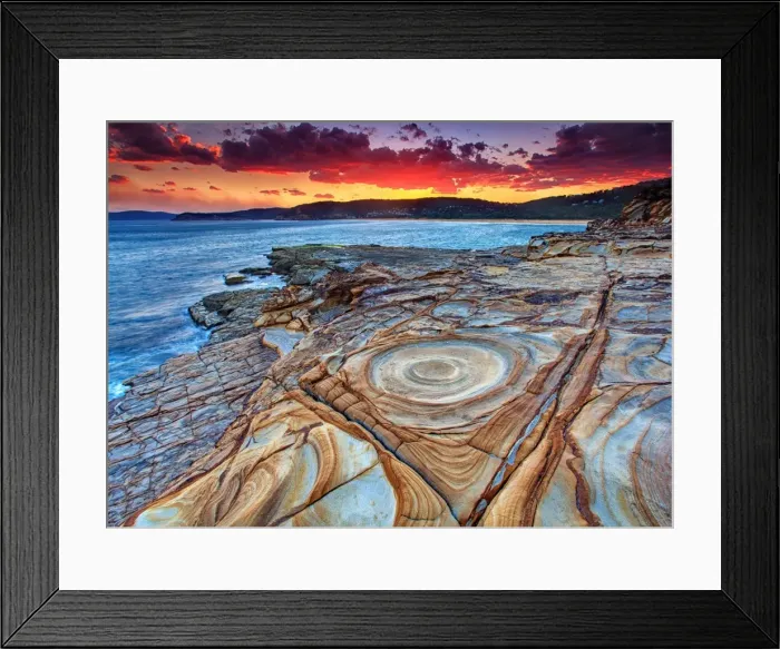 Framed Print : Weathered rocky coastline at sunset