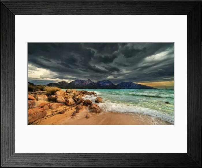 Framed Print : Storm clouds over mountains and beach