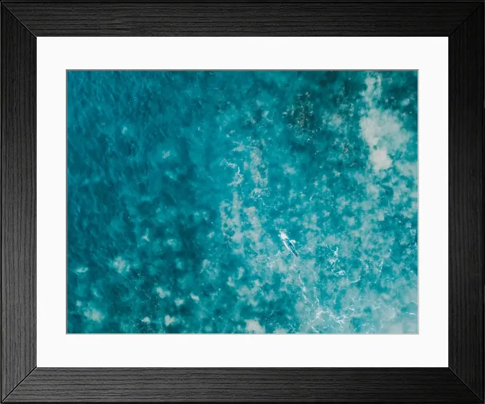 Framed Print : Aerial view of a female surfer on the ocean Framed Print : Aerial view of a female surfer on the ocean