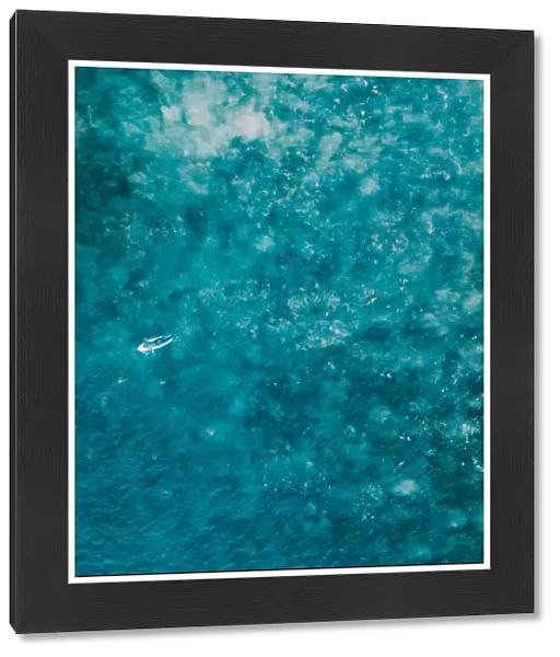 Aerial view of a female surfer on the ocean