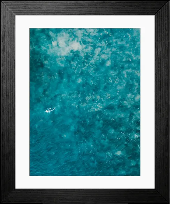 Framed Print : Aerial view of a female surfer on the ocean