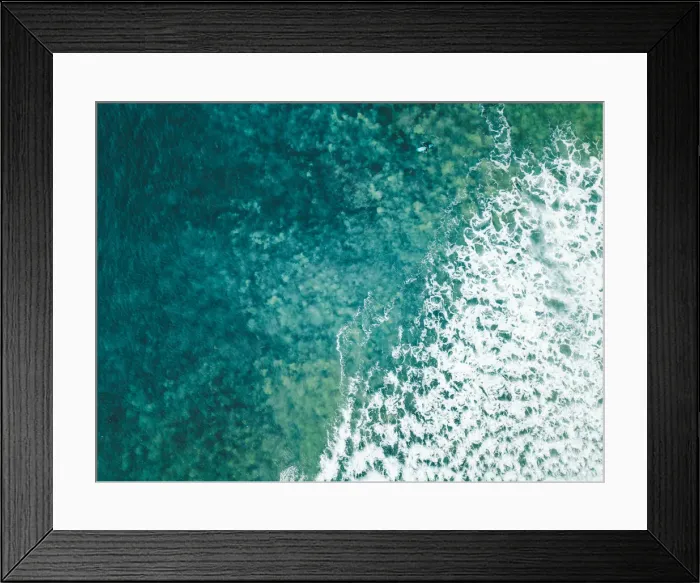 Framed Print : Aerial view of a female surfer on the ocean Framed Print : Aerial view of a female surfer on the ocean