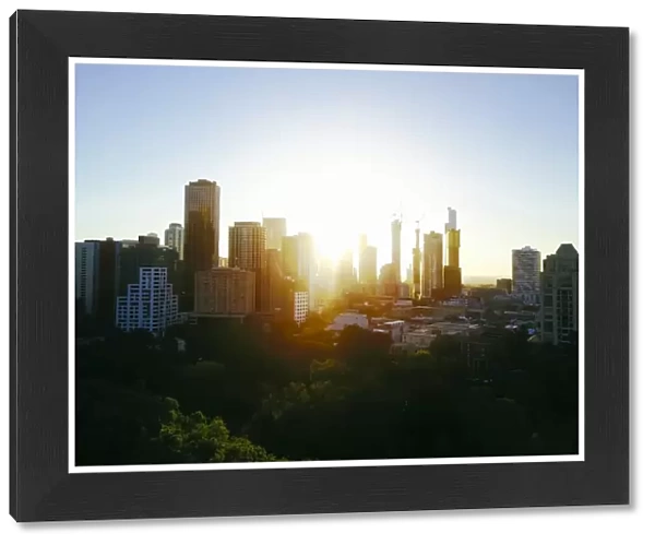 Sunset Aerial view of the Melbourne skyline with trees and Carlton Gardens