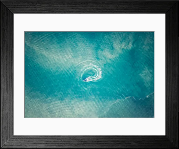 Framed Print : A sailing boat is driving a cycle in the middle of the ocean