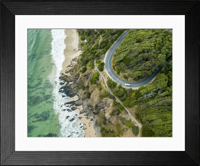 Framed Print : rocky outcrop into ocean with road Framed Print : rocky outcrop into ocean with road
