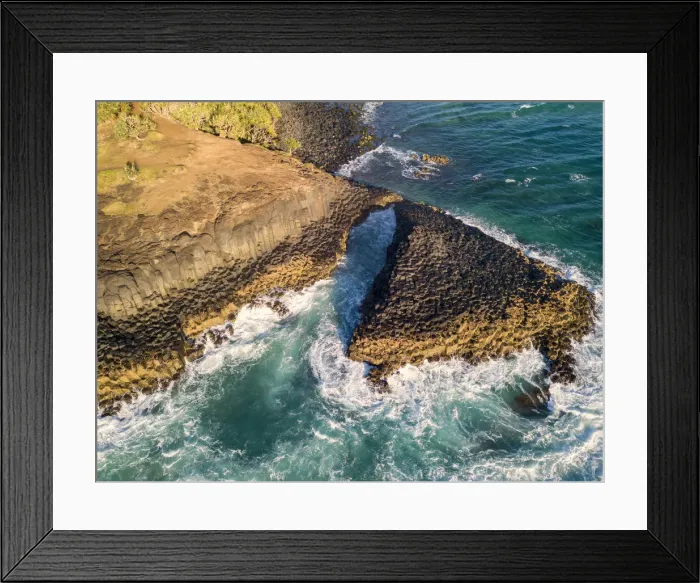 Framed Print : rocky outcrop into ocean at sunrise