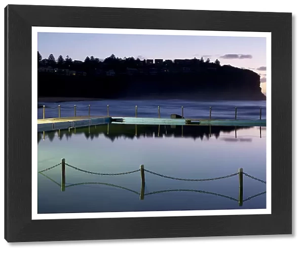 Sea Pool with chain fence reflecting in the still sea water Bilgola New South Wales Australia