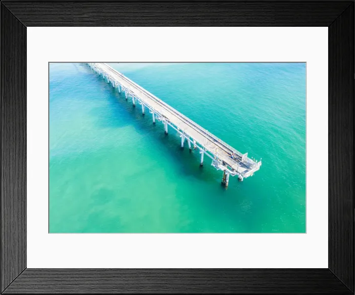 Framed Print : Drone view of a Long sand pumping jetty out into the clear ocean water Framed Print : Drone view of a Long sand pumping jetty out into the clear ocean water