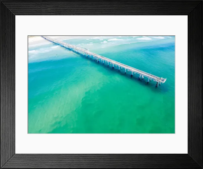 Framed Print : Drone view of a Long sand pumping jetty out into the clear ocean water Framed Print : Drone view of a Long sand pumping jetty out into the clear ocean water