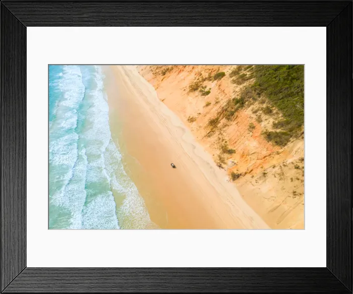 Framed Print : Aerial view of sand dunes with vehicles travelling along the sand and the ocean Framed Print : Aerial view of sand dunes with vehicles travelling along the sand and the ocean
