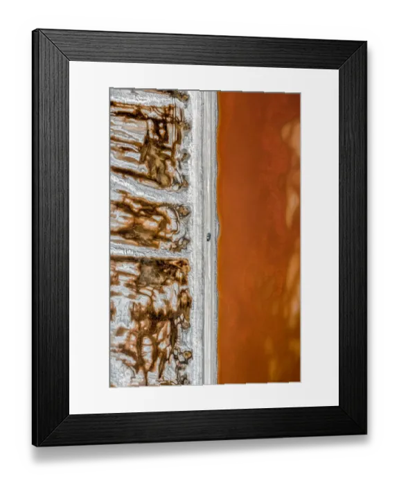 Framed Print : Aerial shot of an dirt track and a truck alongside vibrant coloured salt ponds Framed Print : Aerial shot of an dirt track and a truck alongside vibrant coloured salt ponds
