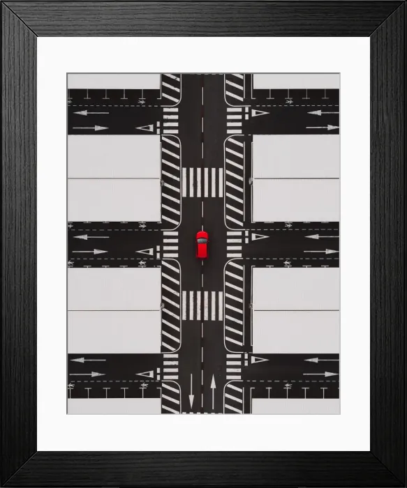 Framed Print : Close up drone shot of an abandoned airport parking terminal and a red car at the centre