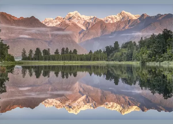 Snowy mountain peaks of Mount Cook and Mount Tasman reflected in Lake Matheson in the