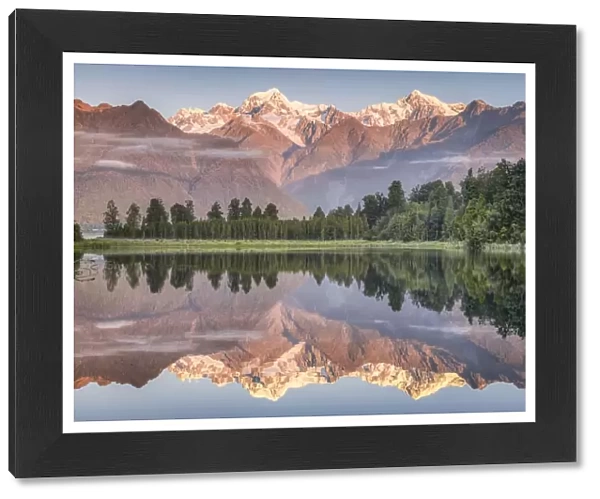 Snowy mountain peaks of Mount Cook and Mount Tasman reflected in Lake Matheson in the